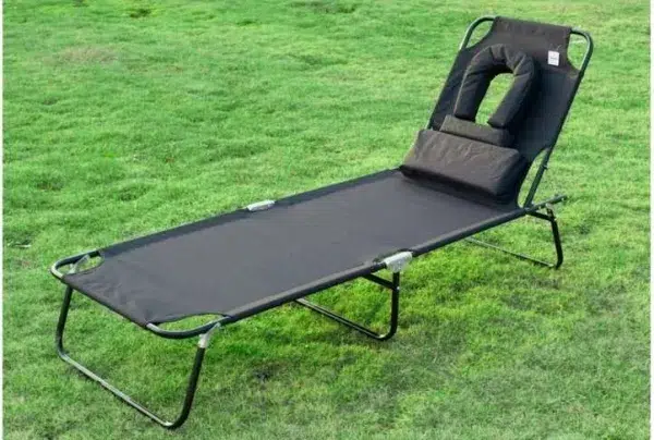 Black sun lounger with reading hole & pillow